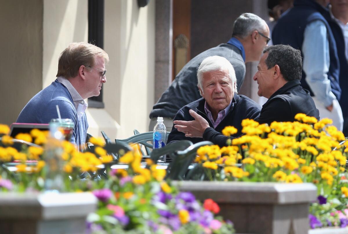 NFL Commissioner Roger Goodell, left, and Patriots owner Robert Kraft, center, chat with Robert Iger, chief executive officer of the Walt Disney Co., in Sun Valley, Idaho, on Sunday during a business conference. Goodell and Kraft will be in Chicago on Monday for an NFL owners meeting.