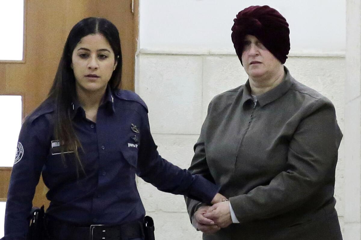 Former teacher Malka Leifer is brought to a courtroom in Jerusalem.