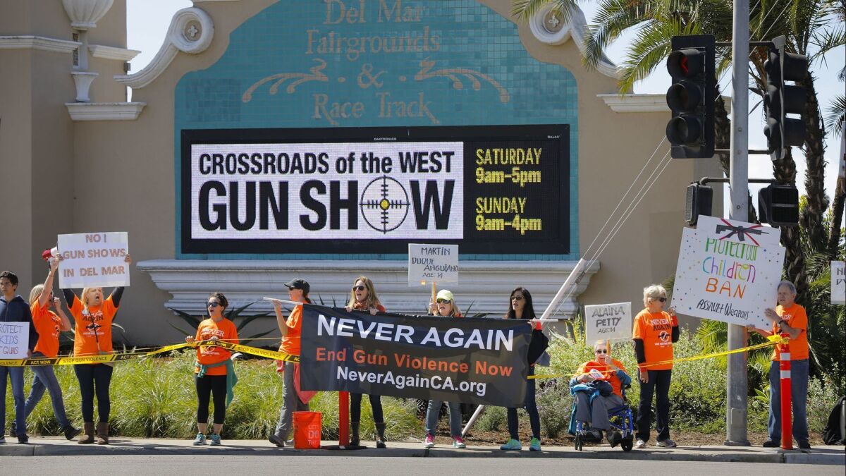 Members of NeverAgainCa protest outside the Crossroads of the West Gun Show at the Del Mar Fairgrounds in March 2018.