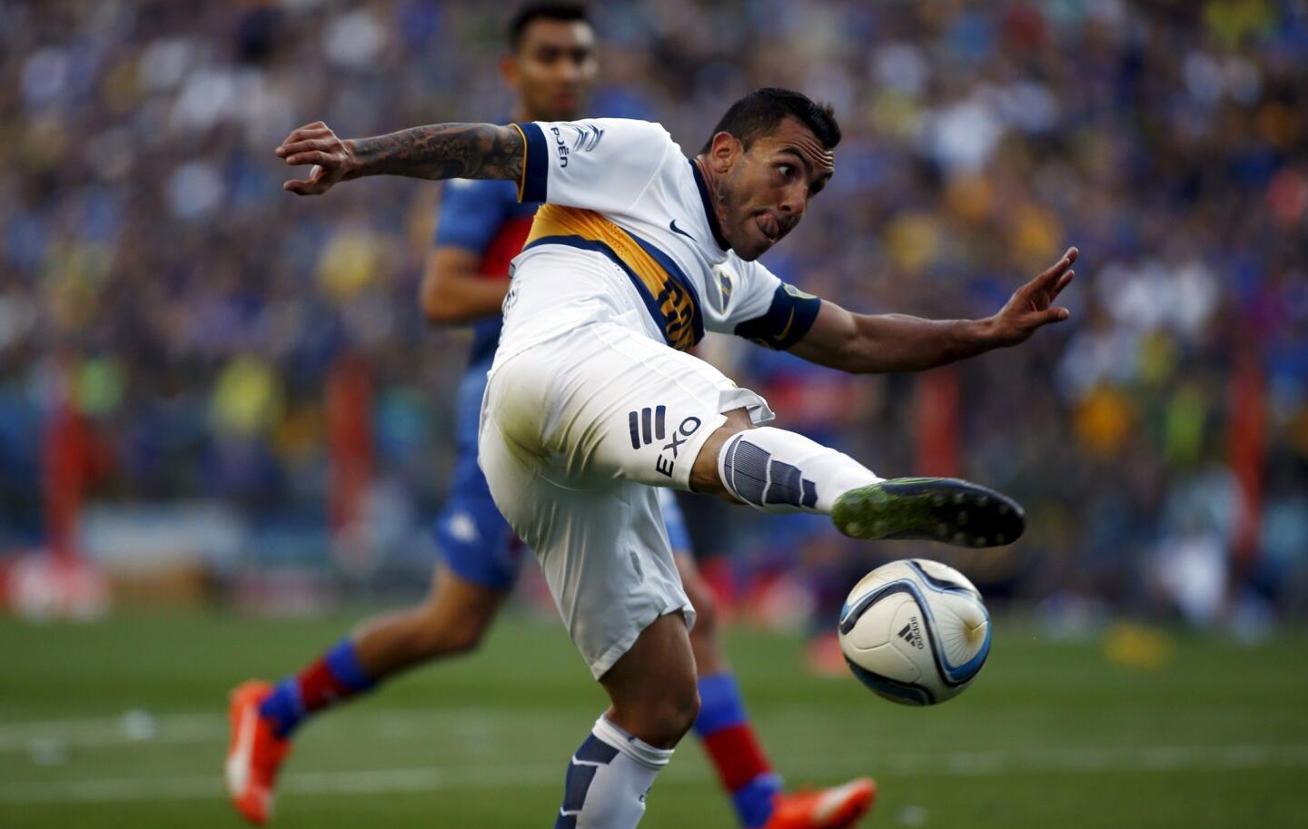 Tevez tries to kick the ball during their Argentine First Division soccer match against Tigre in Buenos Aires
