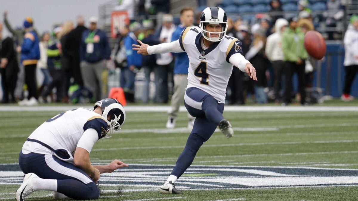Rams kicker Greg Zuerlein (4) kicks as quarterback Austin Davis holds during warmups before a game against the Seattle Seahawks on Sunday.
