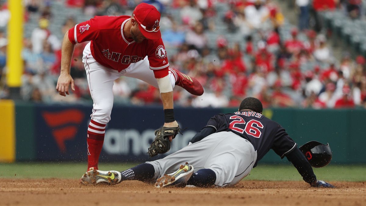 Cleveland Indians center fielder Rajai Davis beats a tag by the Angels' Zack Cozart and steals second base Wednesday.