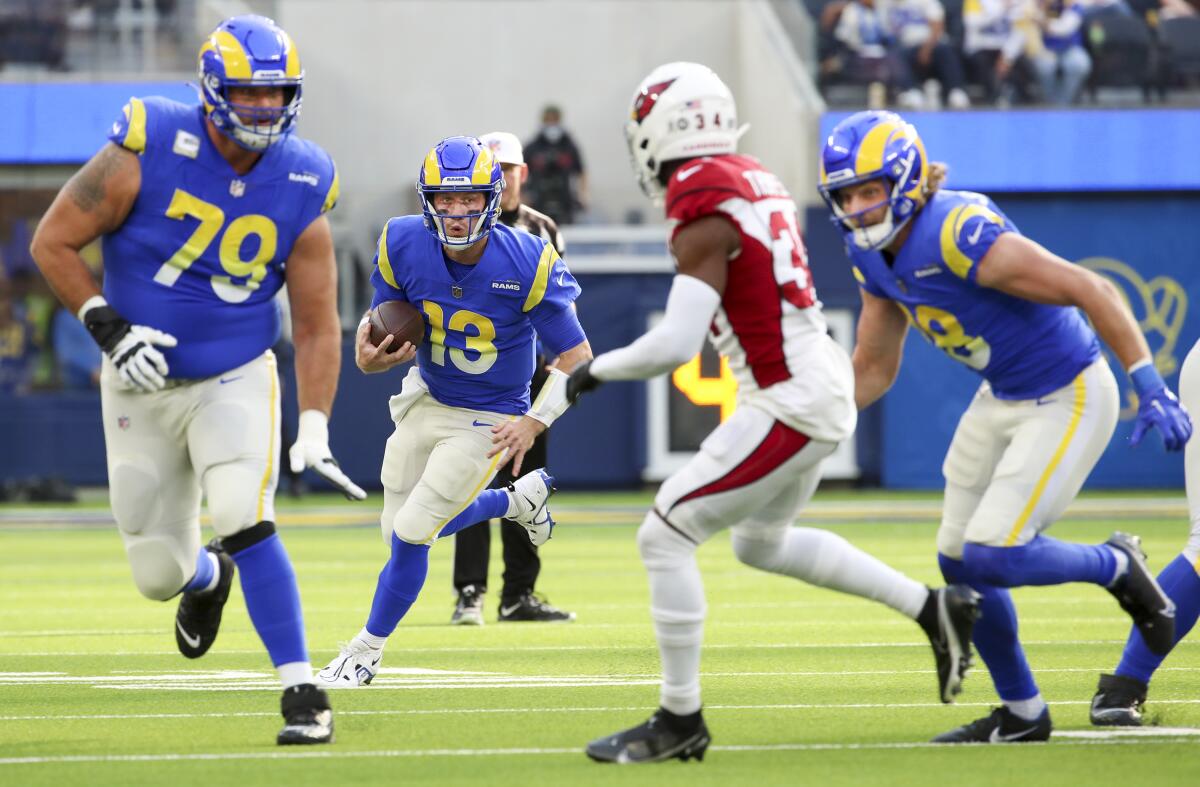 Rams' John Wolford carries the ball through the Cardinals' defense
