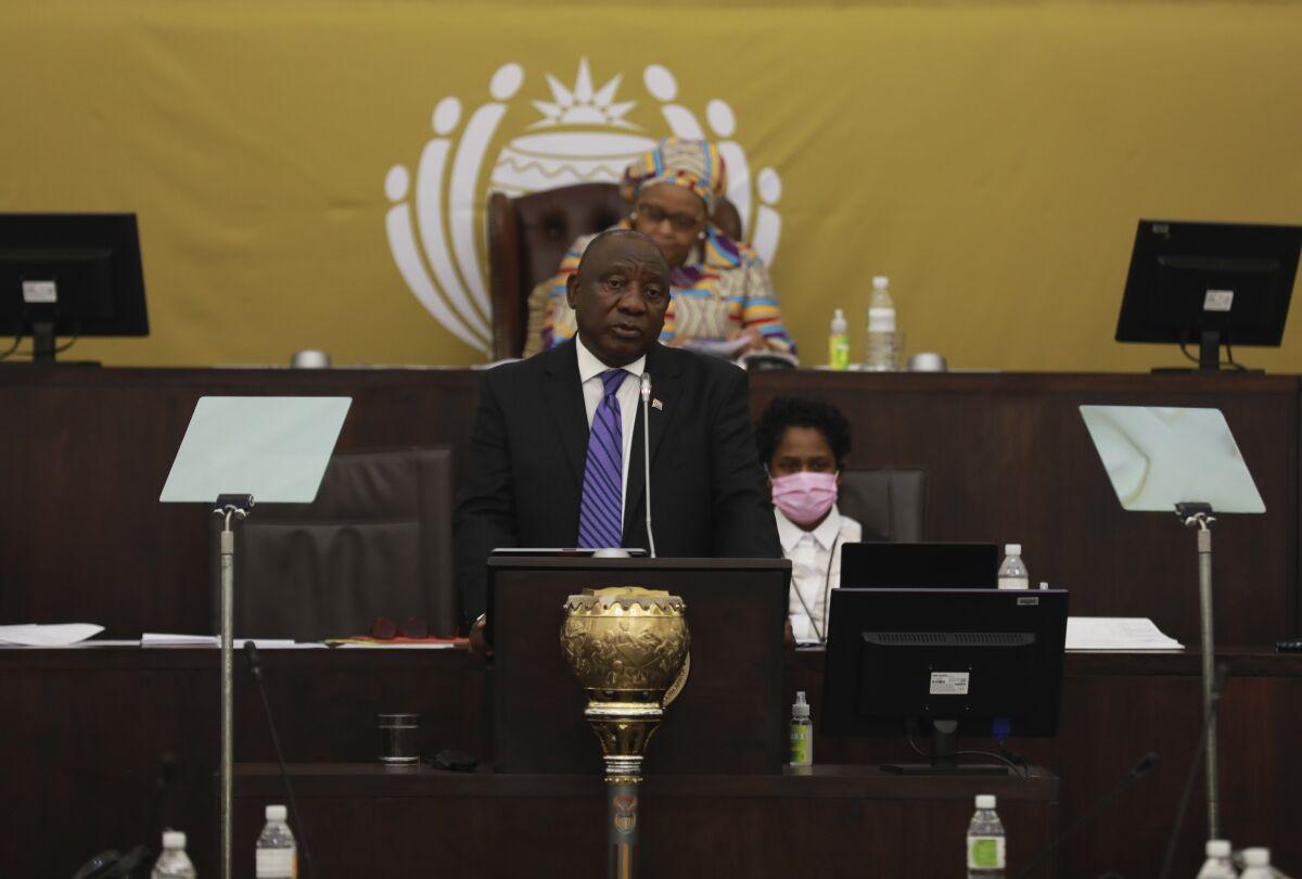 President Cyril Ramaphosa addresses parliament in Cape Town, South Africa, Thursday, June 9, 2022 after a delayed start to proceedings because of interruptions from opposition parties. Ramaphosa is facing the biggest challenge to his presidency and is expected to face calls from opposition lawmakers to step down pending a criminal investigation into allegations that he tried to cover up the theft of $4 million from his game farm in the northern Limpopo province.(AP Photo/Nardus Engelbrecht)