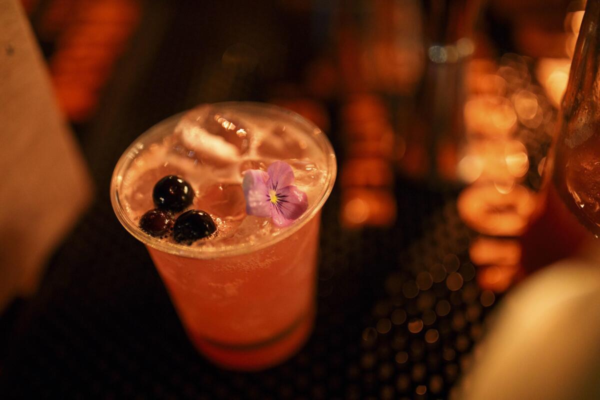 Sassafras Saloon offers a "Blues & Booze," with Bulleit rye, blueberry puree, white tea lavender syrup and garnished with blueberries and flowers during a hot opening night of The Taste.