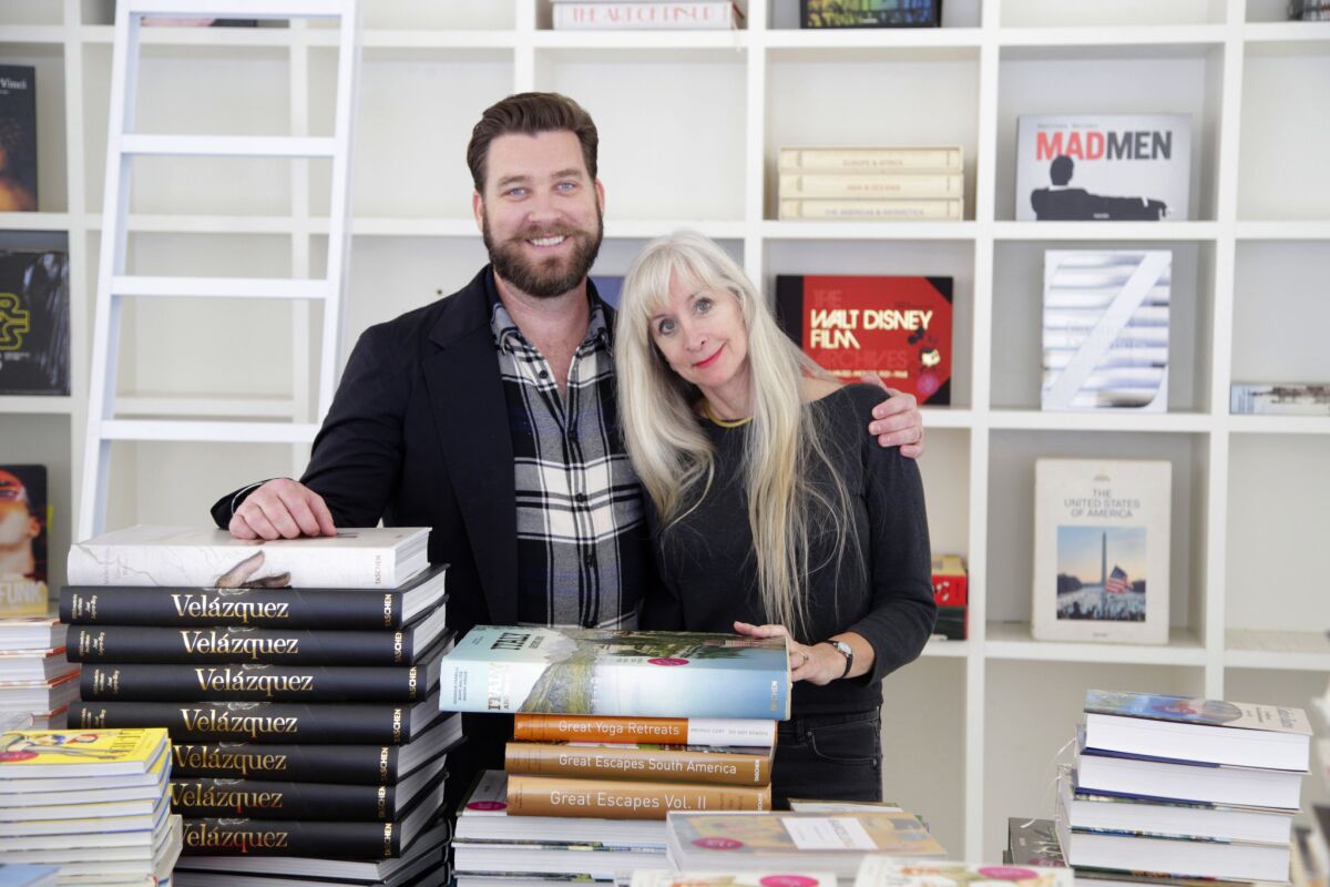 The Los Angeles headquarters of Taschen publishing is moving from its historic office at Hollywood's Crossroads of the World building. Pictured are editors Creed Poulson, left, and Dian Hanson.