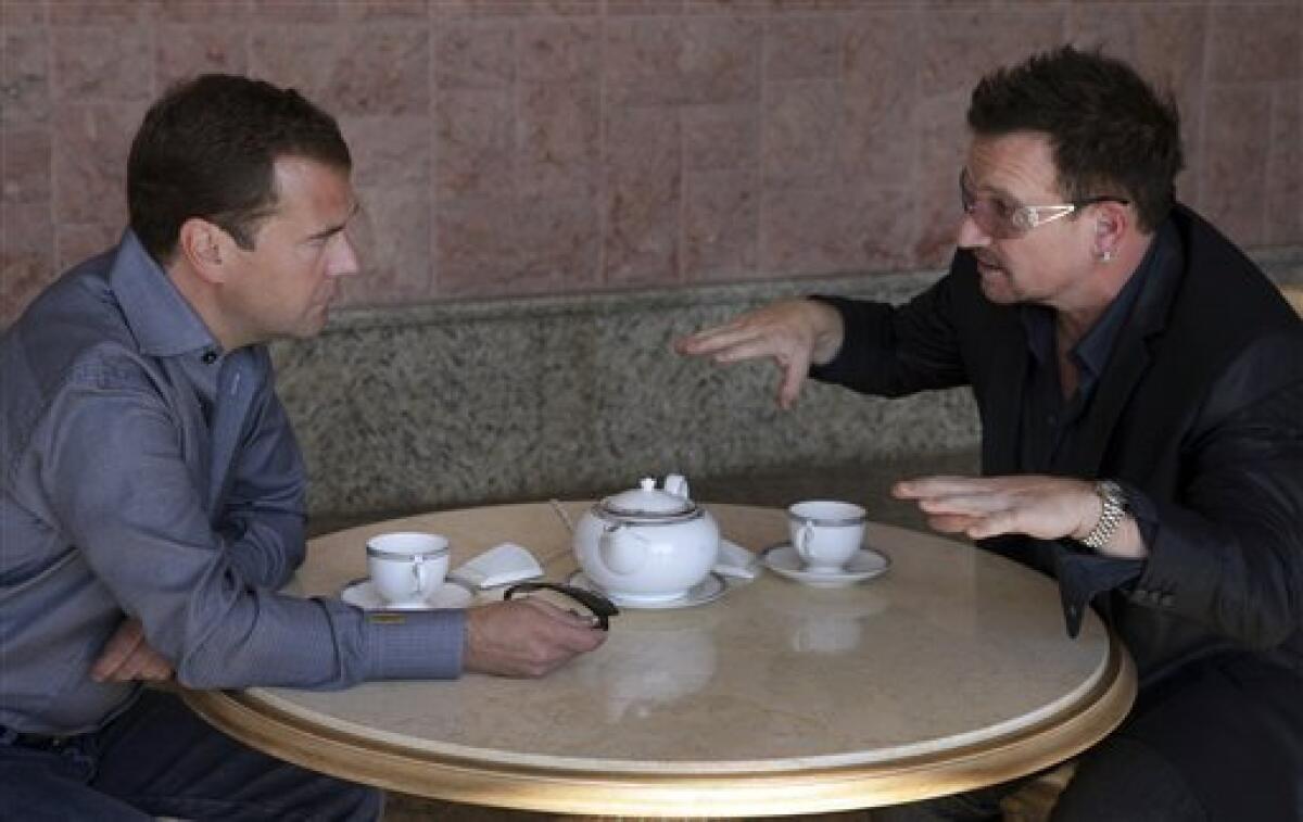 FILE - This is a Tuesday, Aug. 24, 2010 file photo of Russian President Dmitry Medvedev, left, meeting with Bono, the lead singer of Irish band U2,t, in the Bocharov Ruchei residence near the Russia's Black Sea resort of Sochi.(AP Photo/RIA-Novosti, Mikhail Klimentyev, Presidential Press Service, File)