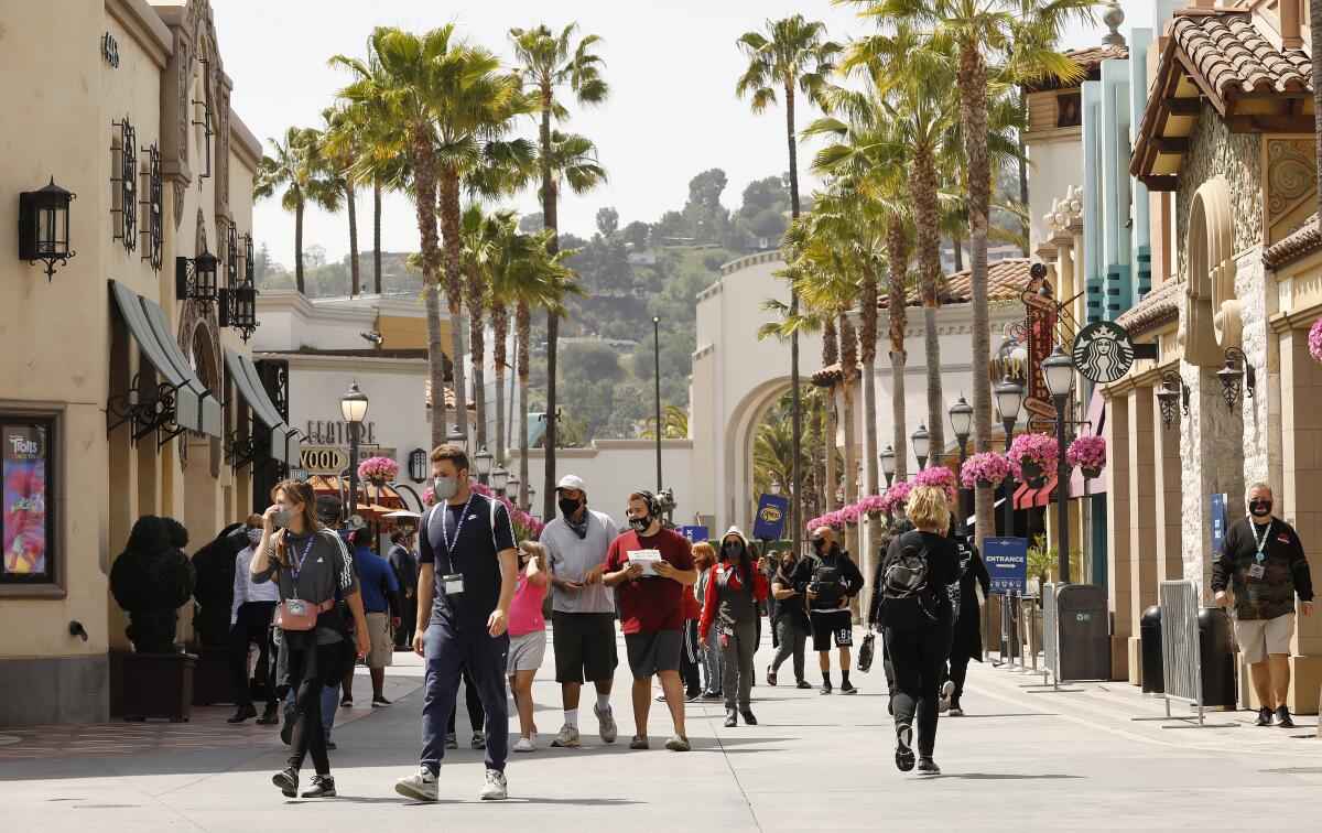 Parkgoers walk outside at Universal Studios Hollywood