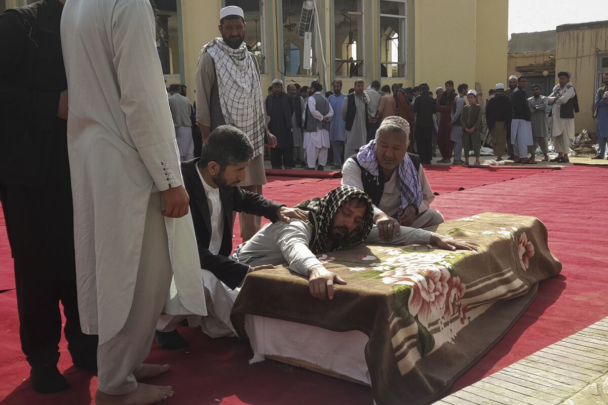 Relatives and residents attend a funeral ceremony for victims of a suicide attack at the Gozar-e-Sayed Abad Mosque in Kunduz, northern Afghanistan, Saturday, Oct. 9, 2021. The mosque was packed with Shiite Muslim worshippers when an Islamic State suicide bomber attacked during Friday prayers, killing dozens in the latest security challenge to the Taliban as they transition from insurgency to governance. (AP Photo/Abdullah Sahil)