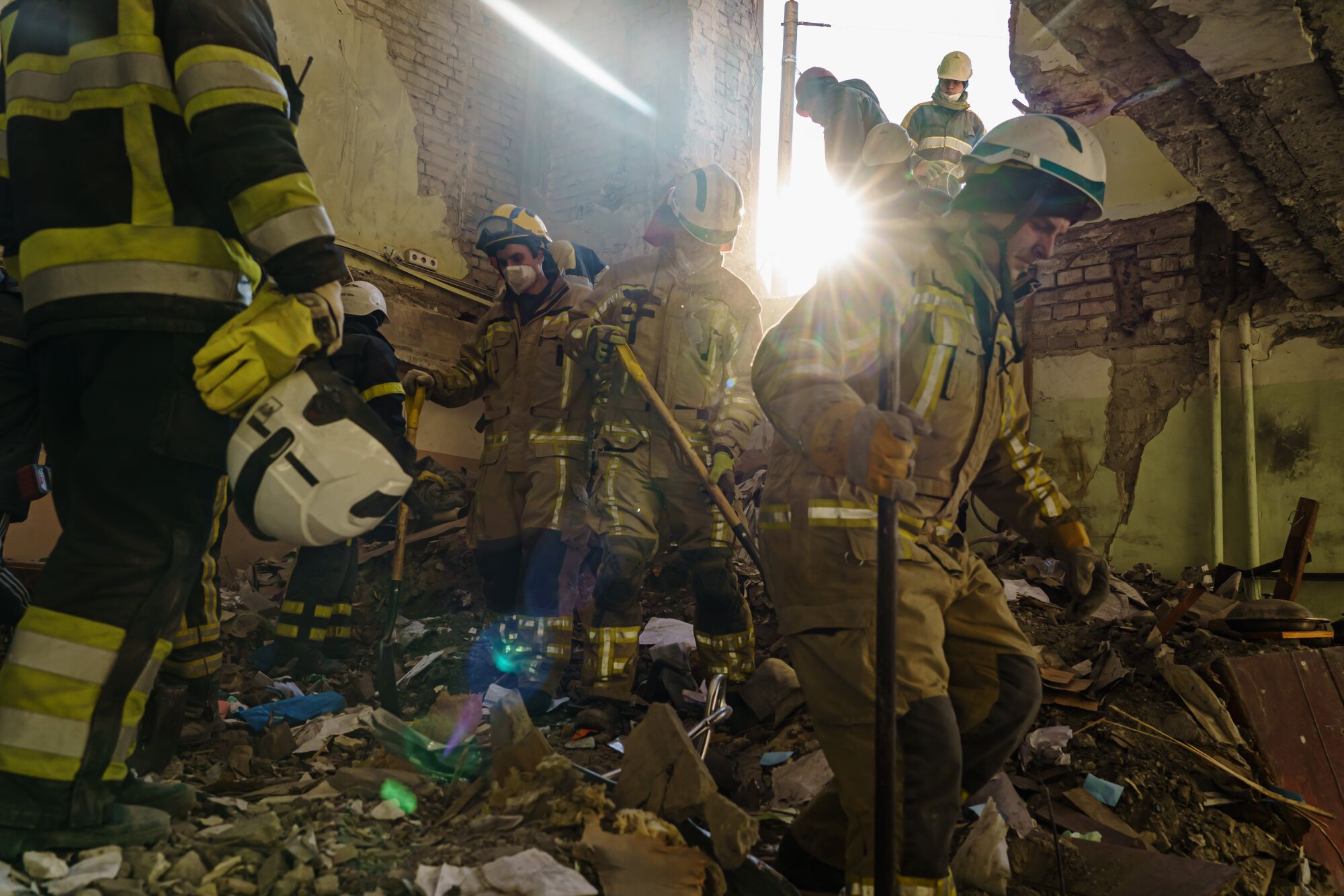 Firefighters clean up debris inside the Kharkiv Regional Administration building in Kharkiv, Ukraine.
