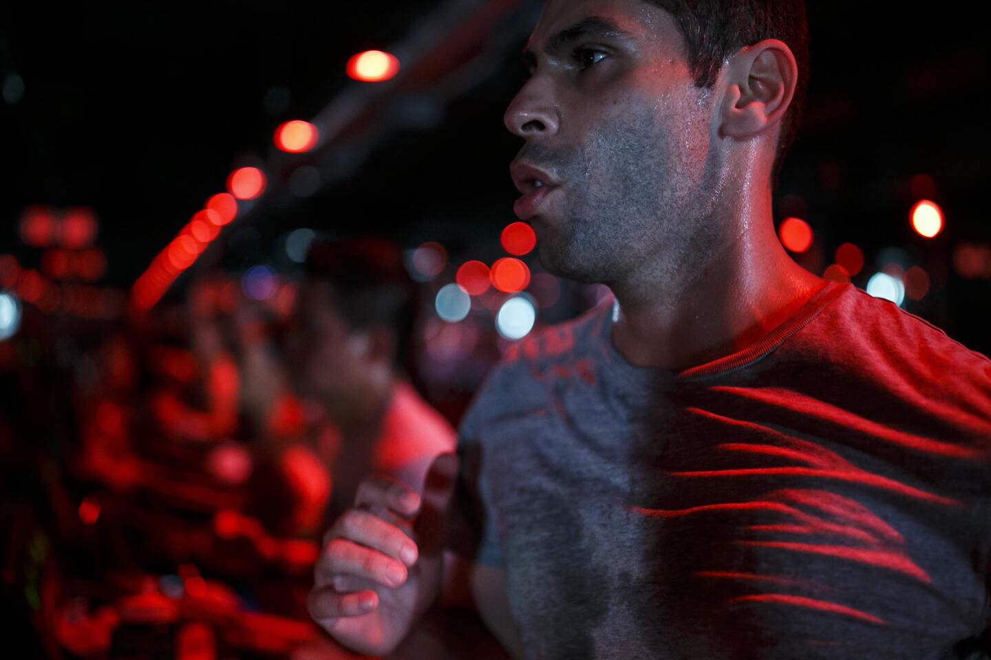 Barry's Bootcamp has customers breathing hard during a workout session focusing on legs and glutes.