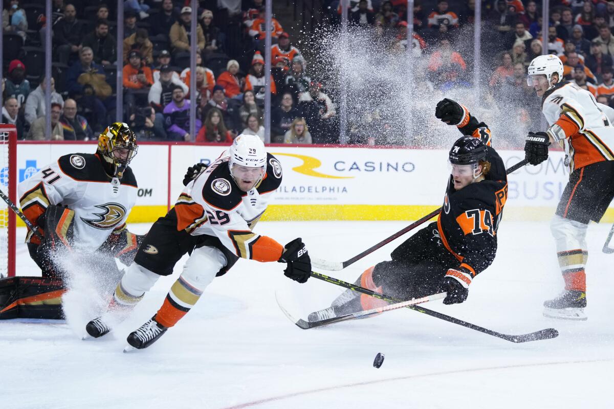 The Ducks' Dmitry Kulikov clears the puck away from the Philadelphia Flyers' Owen Tippett during the second period.