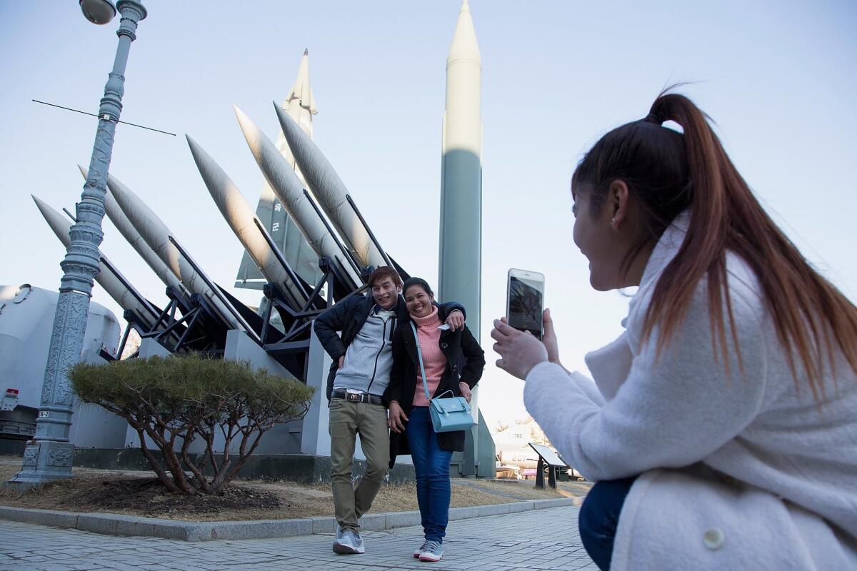 South Koreans take pictures with model missiles including a North Korean Scud-B at the War Memorial of Korea in Seoul.