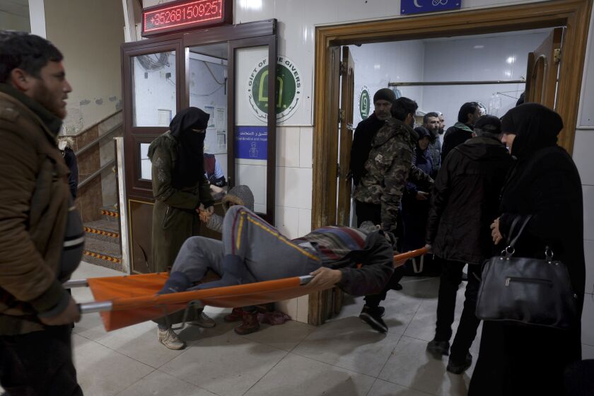 People carry a man injured in an earthquake into the al-Rahma Hospital in the town of Darkush, Idlib province, northern Syria, Monday, Feb. 6, 2023. A powerful earthquake has caused significant damage in southeast Turkey and Syria and many casualties are feared. Damage was reported across several Turkish provinces, and rescue teams were being sent from around the country. (AP Photo/Ghaith Alsayed)