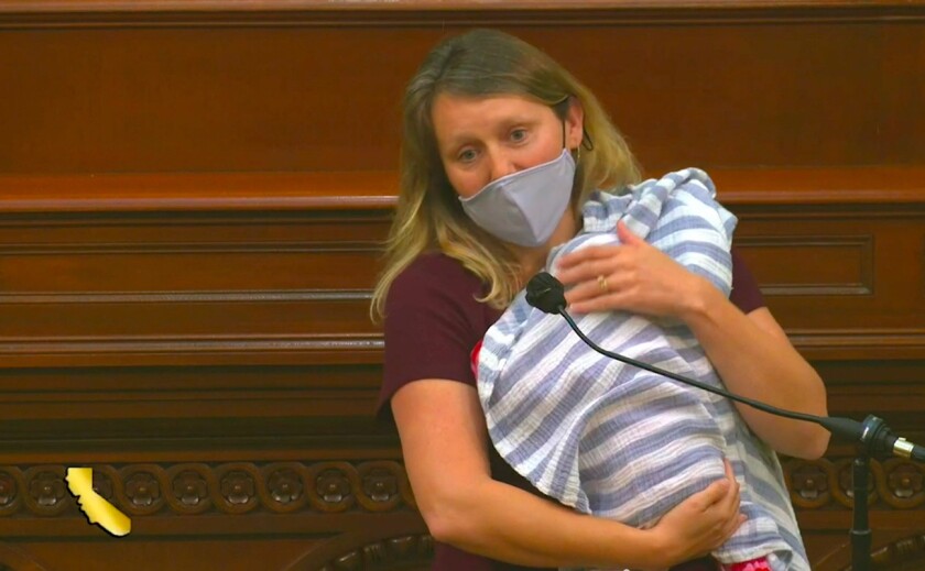 Assemblywoman Buffy Wicks (D-Oakland) holds her daughter and speaks on the Assembly floor on Aug. 31
