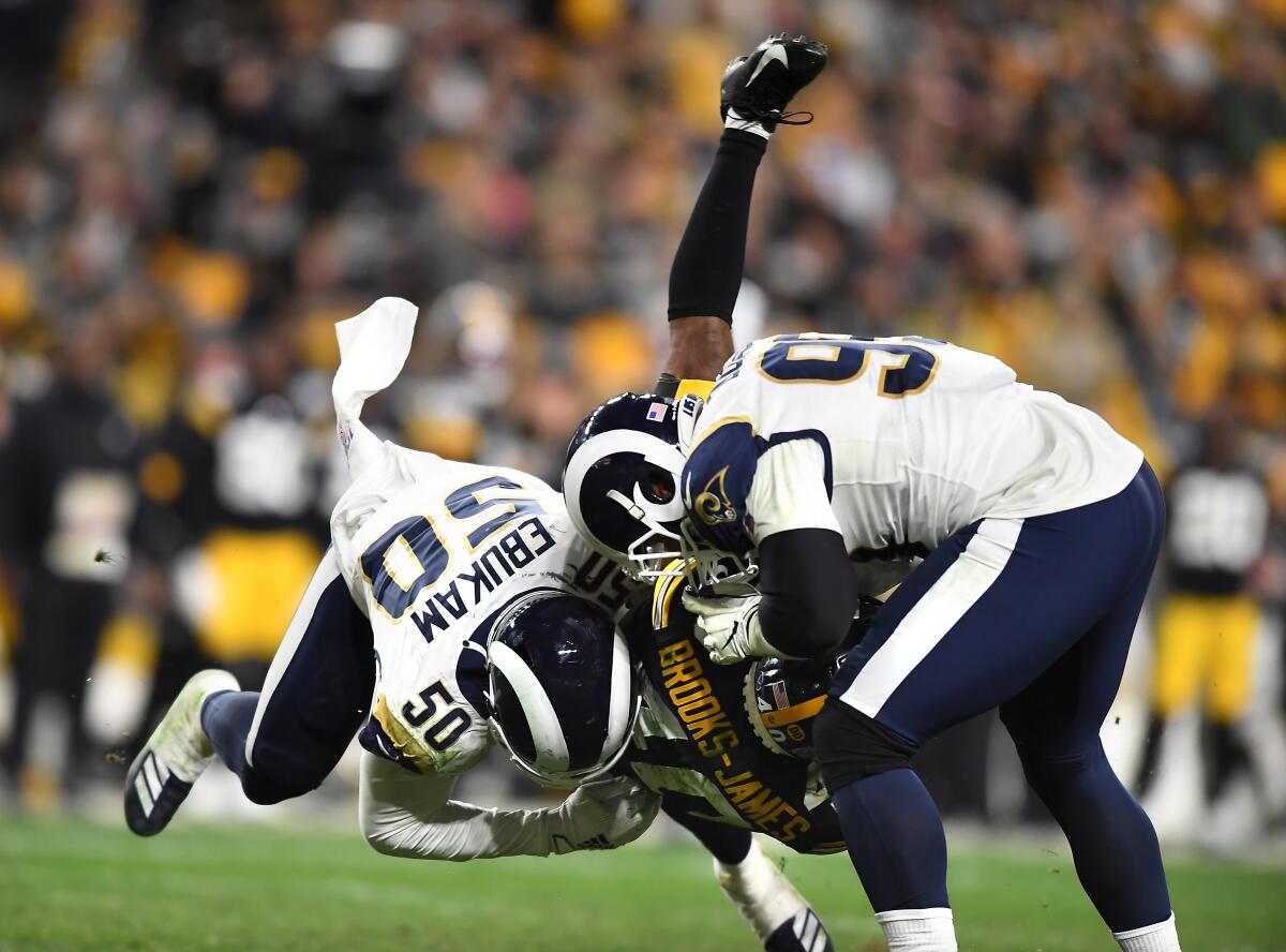 Rams linebacker Samson Ebukam and defensive tackle Aaron Donald bring down Steelers running back Tony Brooks-James in the fourth quarter. 
