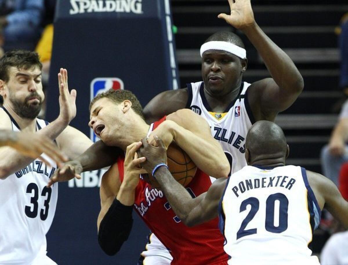 Clippers power forward Blake Griffin is fouled while trying to make a move in the lane against a trio of Grizzlies defenders (from left): center Marc Gasol, power forward Zach Randolph and forward Quincy Pondexter during a game last season.