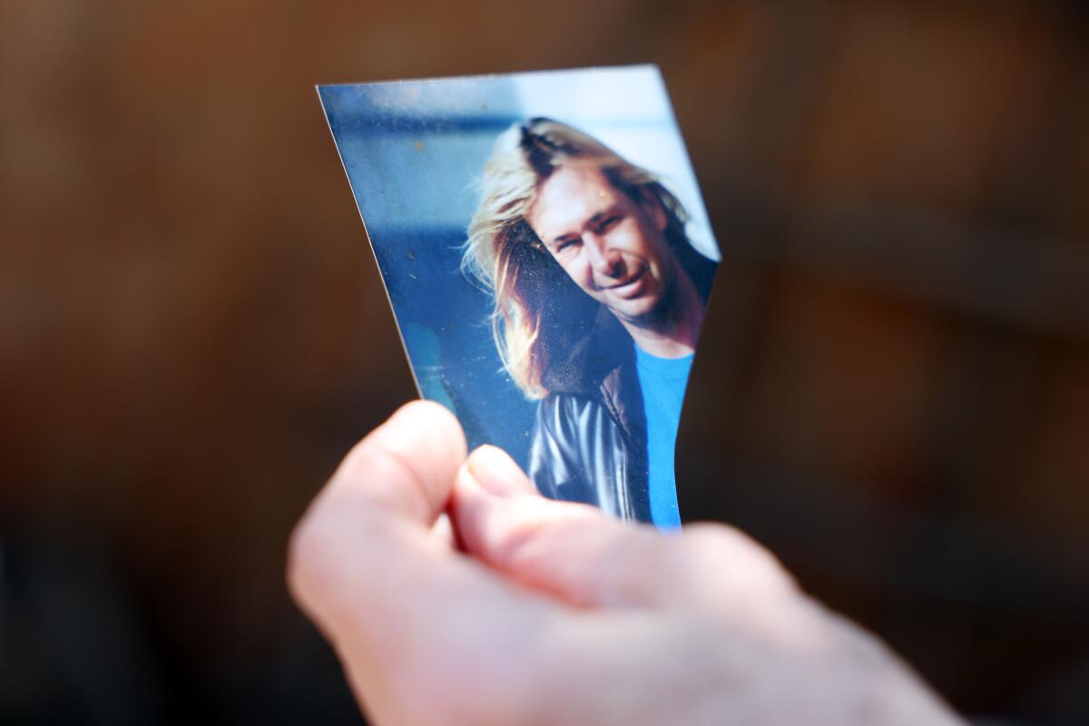 SaraLynn Mandel holds a photograph of Inge Baumbach.