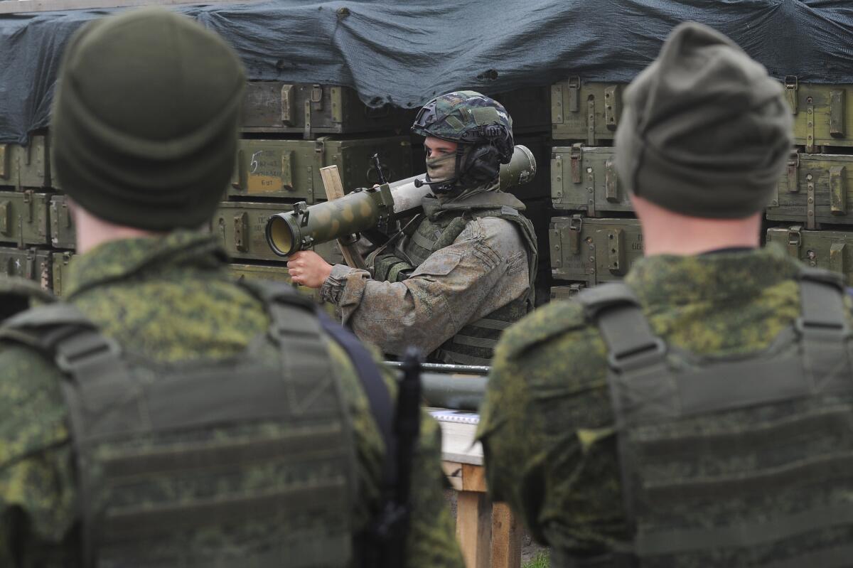 Recruits listen to an instructor during a military training 