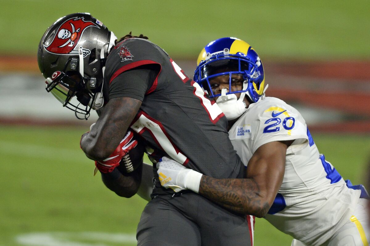 The Rams' Jalen Ramsey tackles the Buccaneers' Ronald Jones.