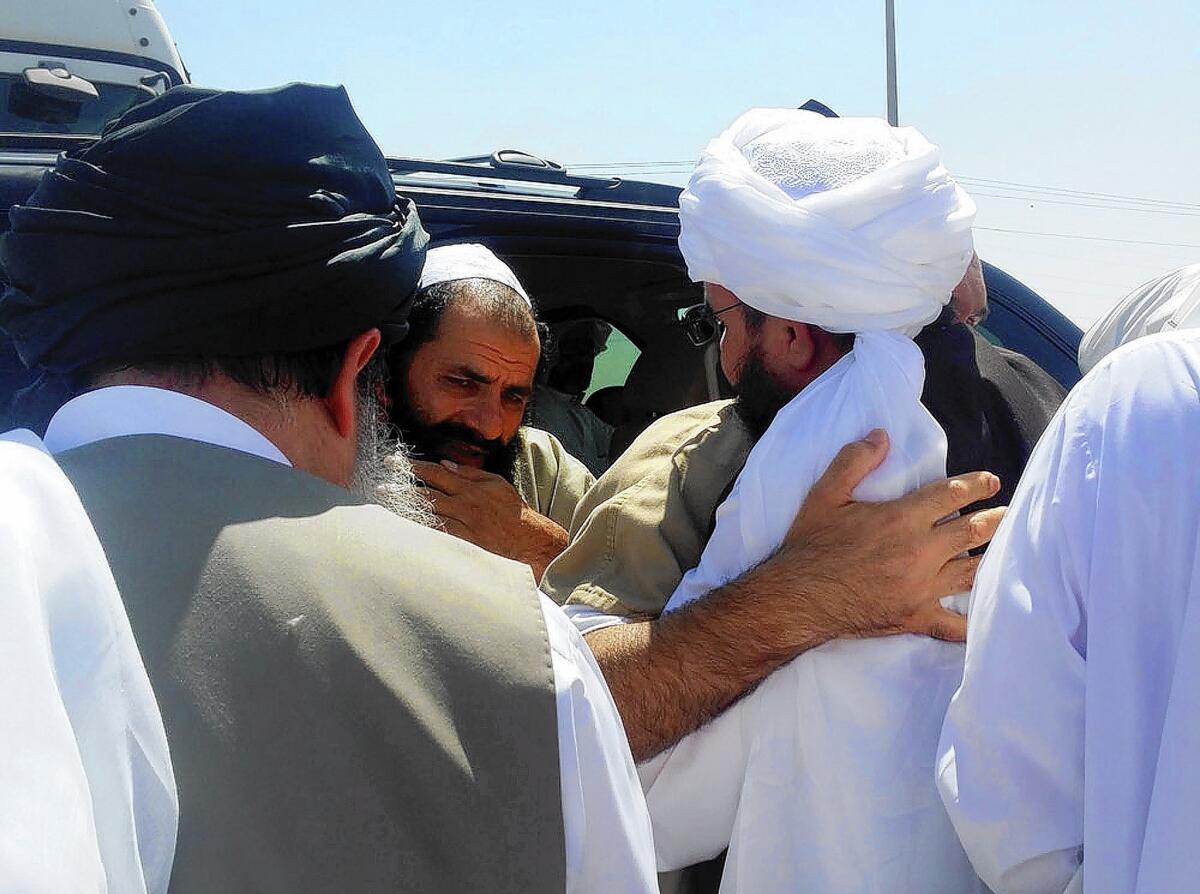 A man reported to be Mohammed Fazl, former chief of staff of the Taliban army, is welcomed at an undisclosed location in Qatar. He is considered the most dangerous of the five Taliban members freed by the U.S. last week.