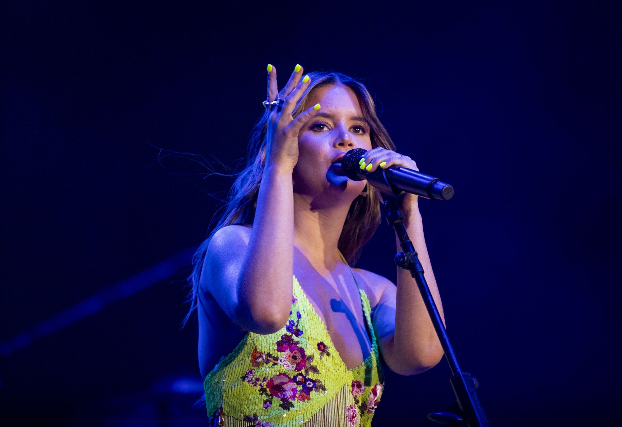 Maren Morris sings into a microphone