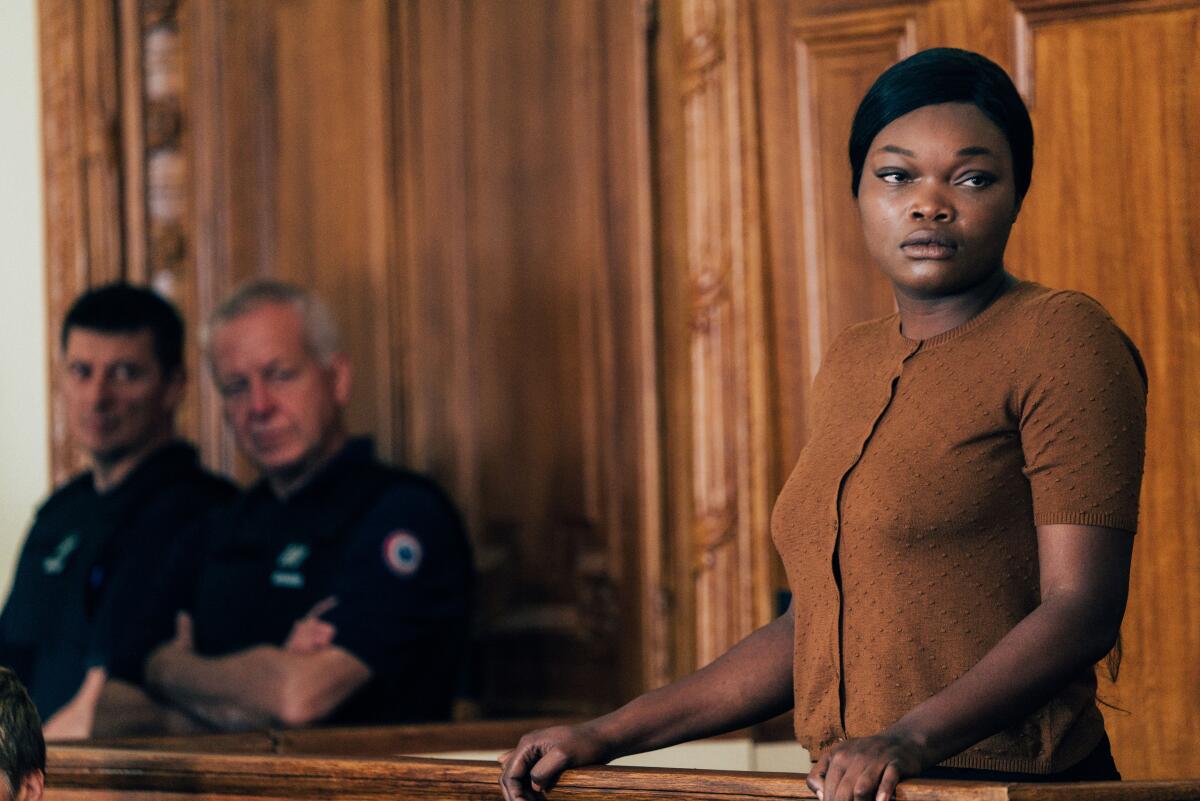 A woman stands on the witness stand.