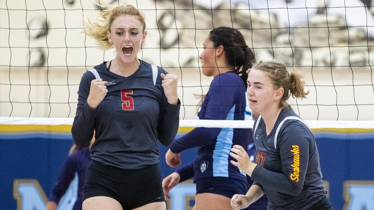 Ocean View High's Helen Reynolds, left, celebrates after winning a point during a nonleague match at Marina on Wednesday.