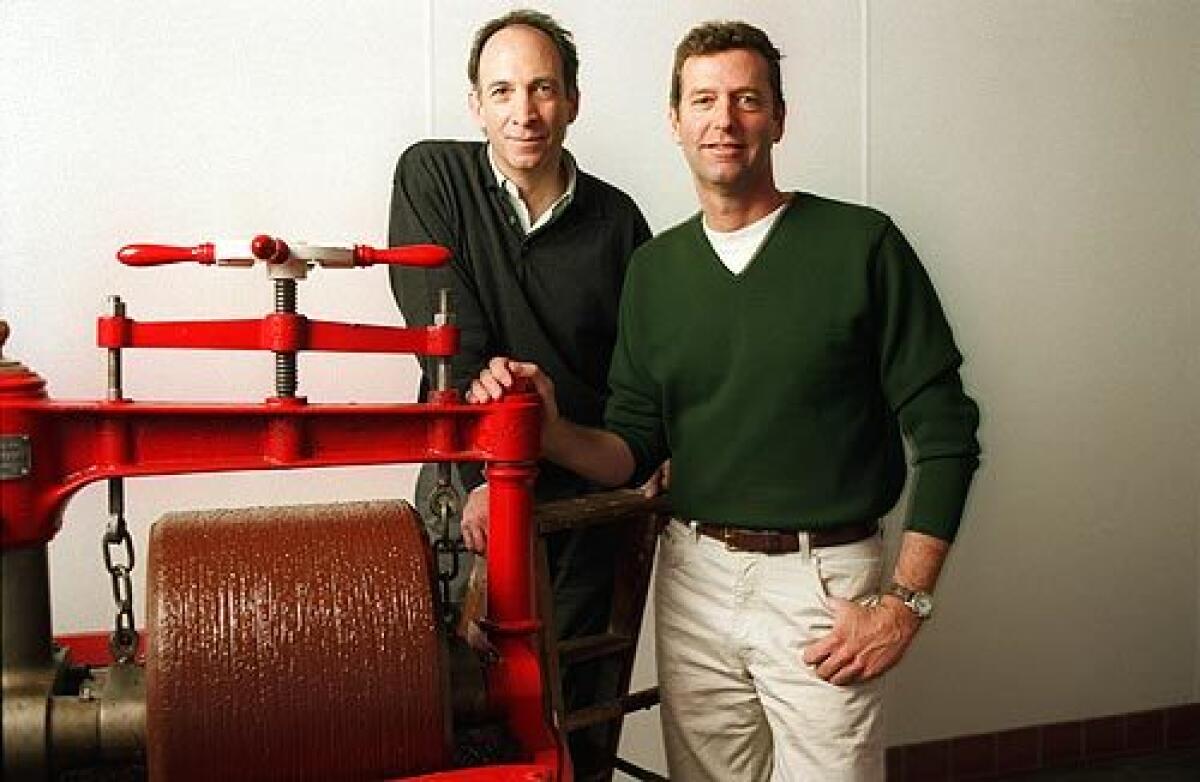 Robert Steinberg, left, and John Scharffenberger of Scharffen Berger Chocolate Maker, in a 1998 photo, pose with a melangeur, a machine whose granite wheels blend chocolate and sugar. Steinberg "changed chocolate from being seen as a mere sweet candy to having the status of a complex and interesting food. A new age of chocolate was started in this country with that company, cookbook author Alice Medrich told The Times.