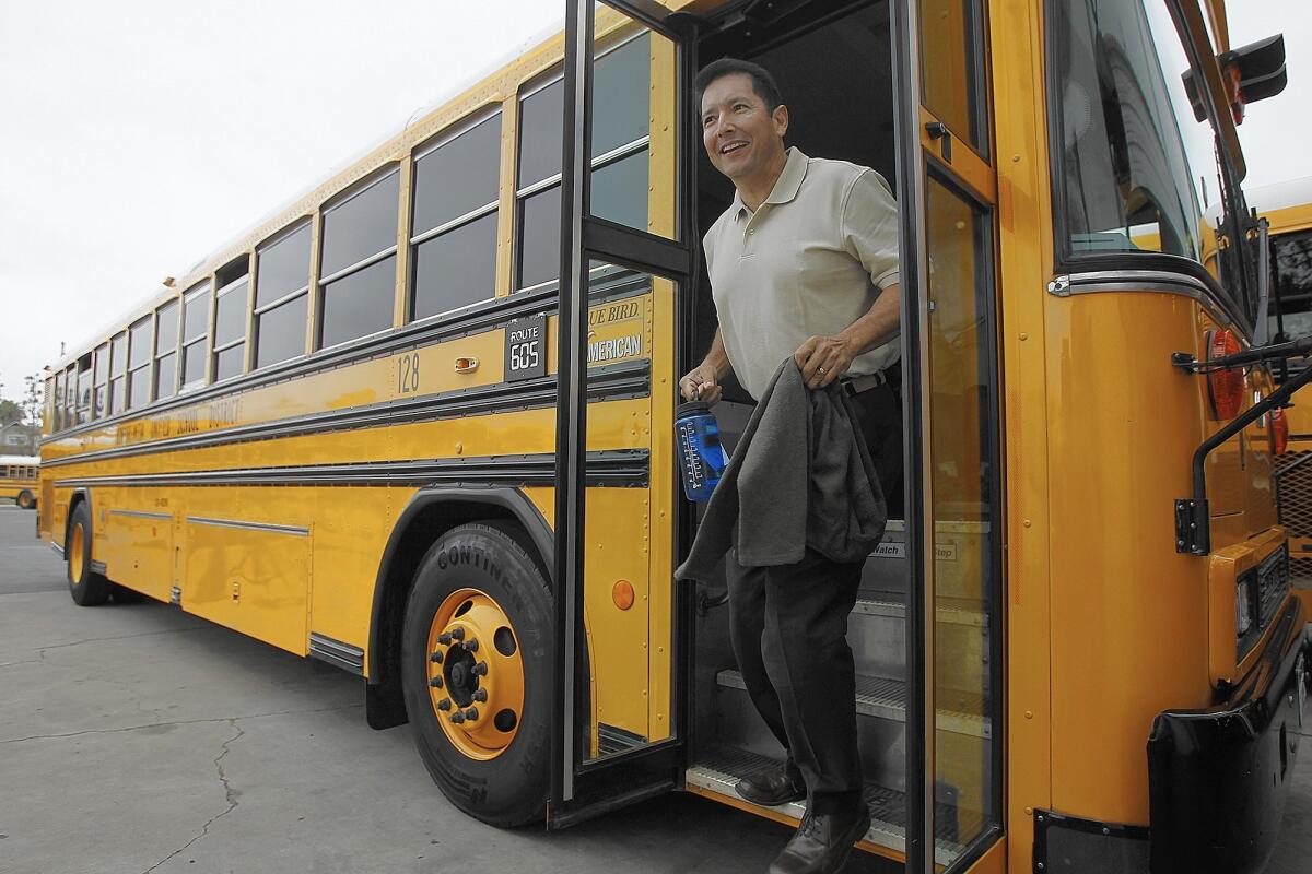 Fred Navarro, superintendent of the Newport-Mesa Unified School District, steps off a school bus after spending a morning riding with students. In a lawsuit filed Thursday, two former district officials allege that Navarro created a workplace of "fear and intimidation."