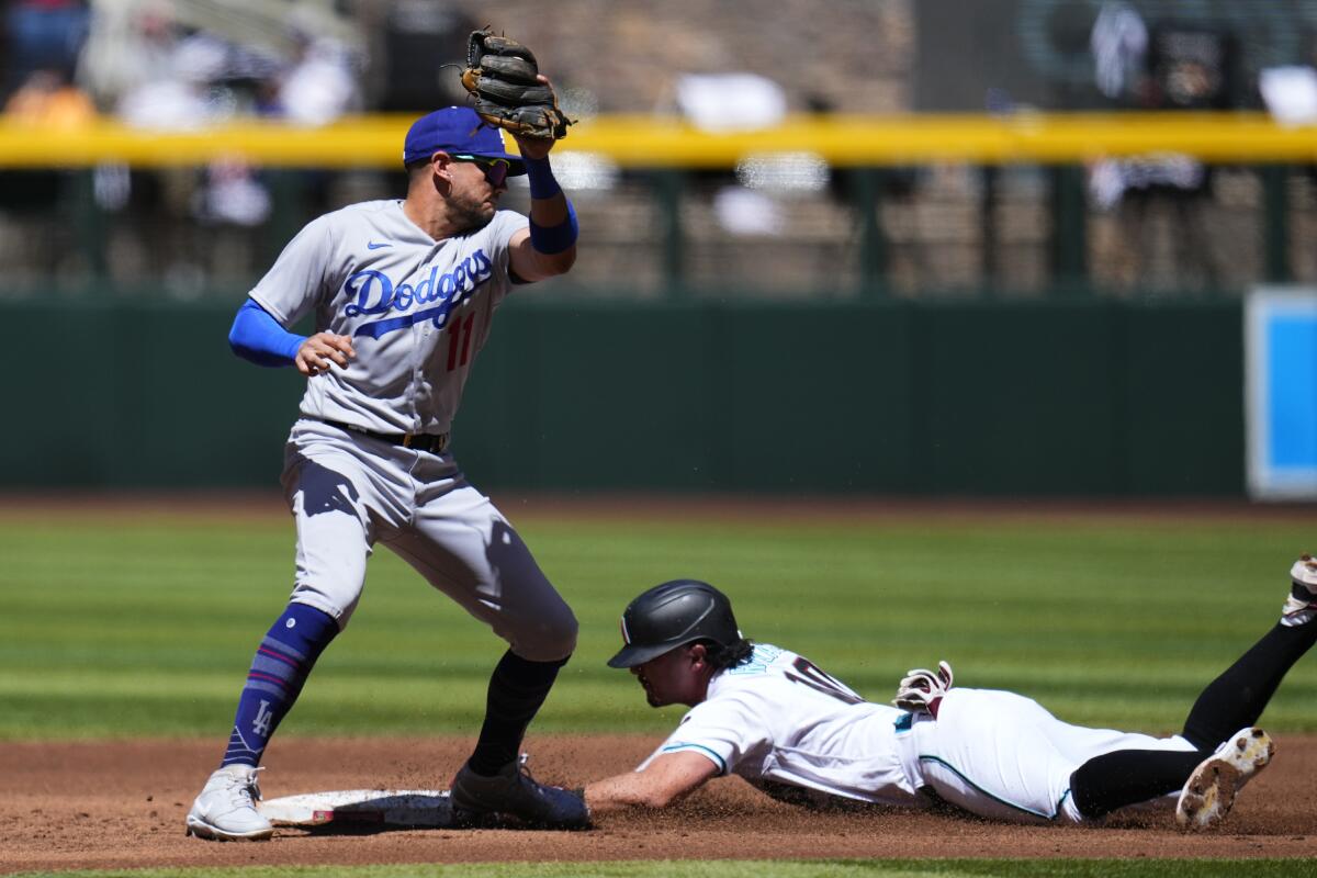 Arizona's Josh Rojas steals second base in front of Dodgers shortstop Miguel Rojas.