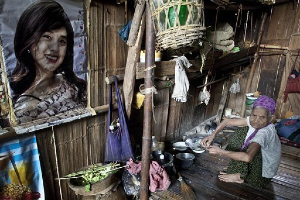 In this photo taken Thursday, July 1, 2010, a Karen woman looks on from her refugee camp home in the Mae Rama Luang Refugee Camp in western Thailand, along the border with Myanmar. The Karen, an ethnic minority people of about 4 million within Myanmar's 43 million, are being pushed by the military from their homes in western Myanmar to the border with Thailand almost daily. Human rights groups and aid workers call it "the hidden Darfur." (AP Photo/David Longstreath)