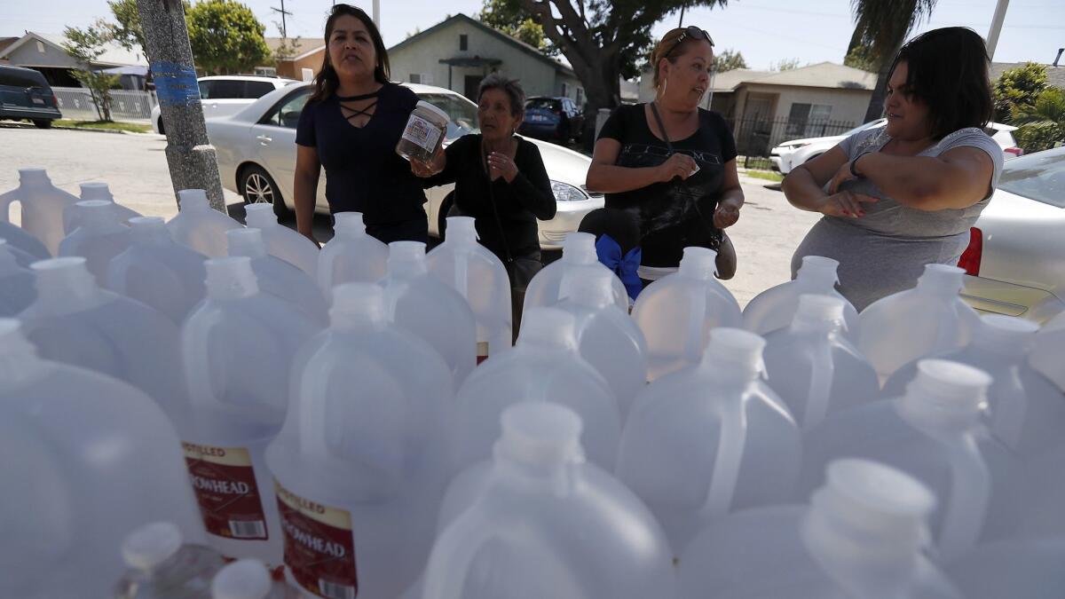 Compton residents pick up donated bottled water.