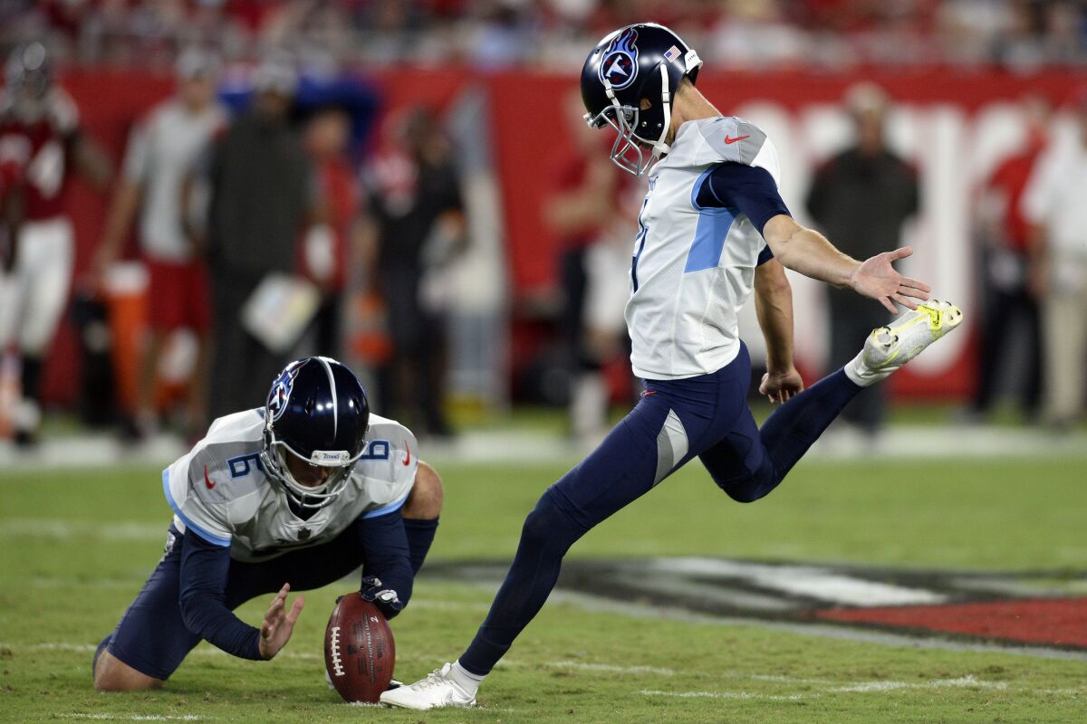 FILE - In this Aug 21, 2021, file photo, Tennessee Titans' Sam Ficken, right, boots a field goal against the Tampa Bay Buccaneers as punter Brett Kern (6) holds during the first half of an NFL preseason football game in Tampa, Fla. Ficken has been added to the injury report with an injured groin and the Titans have signed Michael Badgley to the practice squad. Tennessee opens the season Sunday, Sept. 12, 2021, hosting Arizona. (AP Photo/Jason Behnken, File)