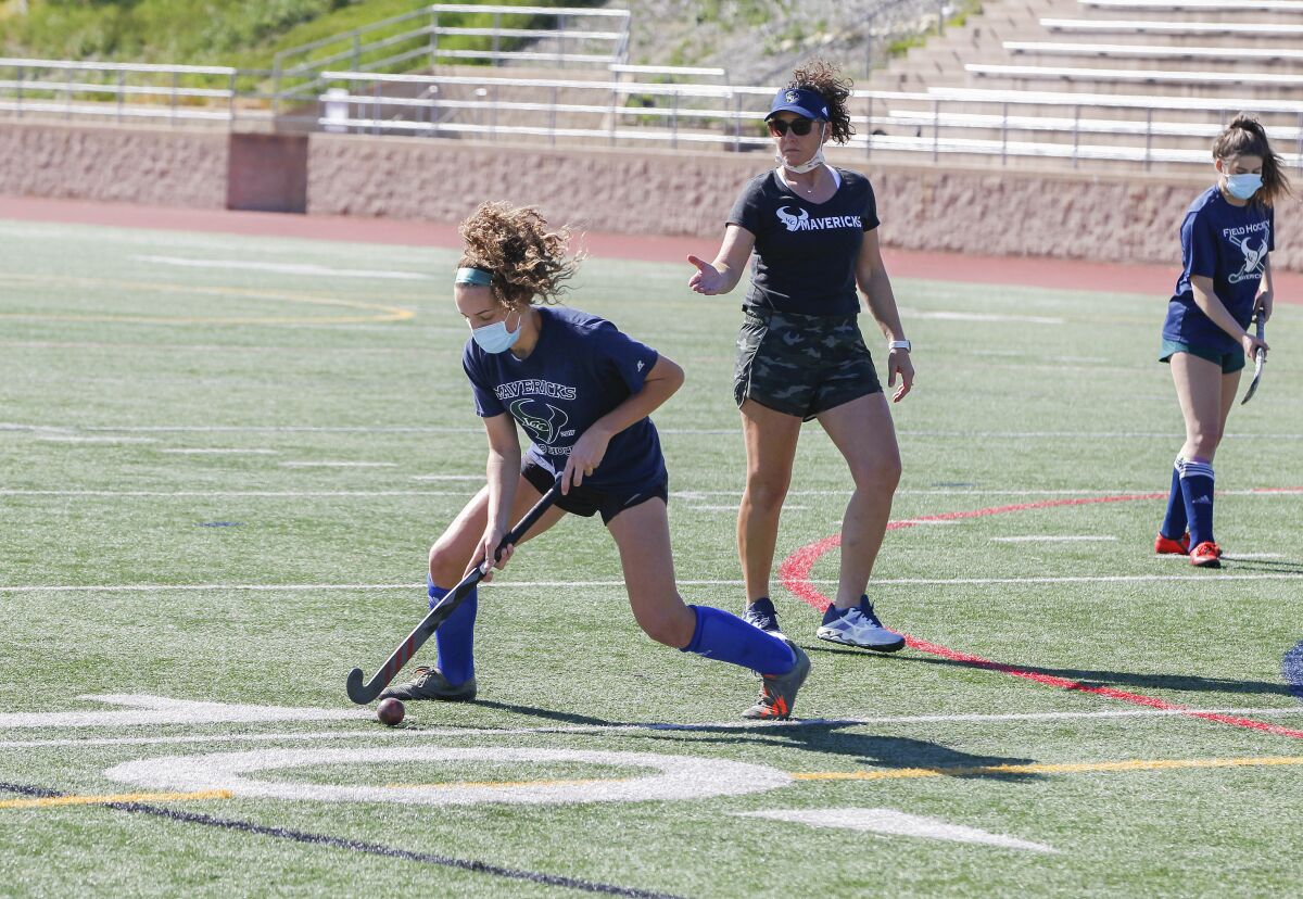 La Costa Canyon field hockey player Mia DiGiulio (left) works out as her mother, Kari DiGiulio (middle), does the coaching.