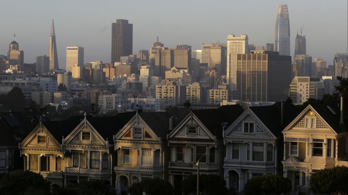 The skyline beyond a row of Victorian houses in San Francisco in 2017.