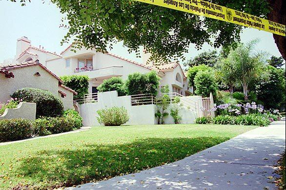 Police tape protects the crime scene at the Bundy Drive condo of Nicole Brown Simpson, where 15 years ago, on June 12, 1994, she and Ronald Goldman were brutally slain. Simpson's ex-husband, former football star O.J. Simpson, was charged with the slayings days later.