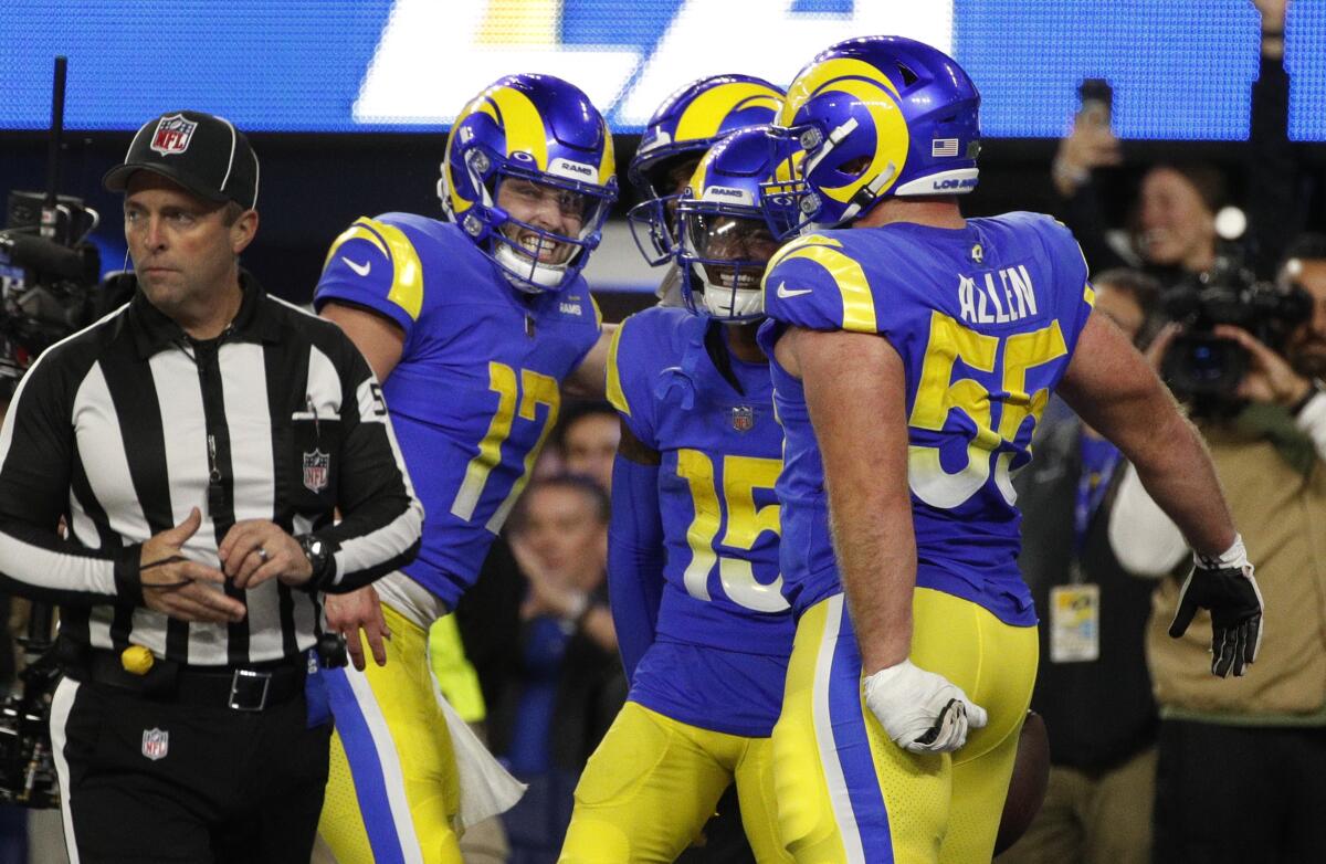 Rams quarterback Baker Mayfield celebrates with wide receiver Van Jefferson and teammates after a touchdown.