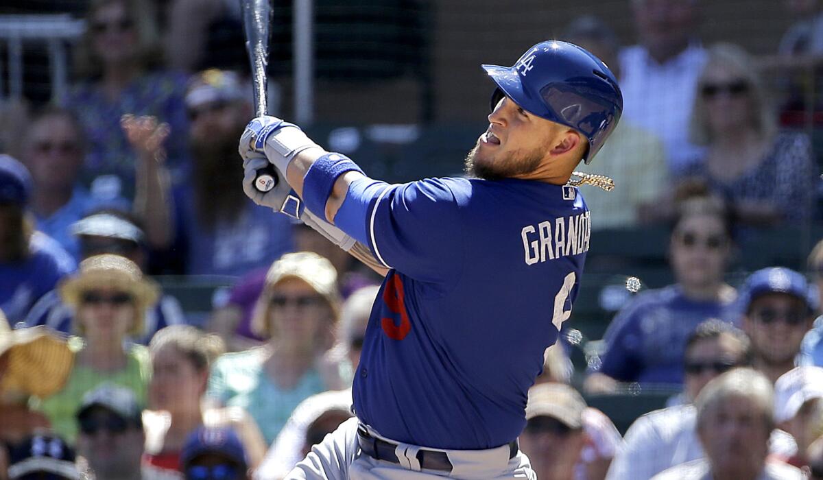 Dodgers catcher Yasmani Grandal follows through on a two-run home run against the Arizona Diamondbacks in the first inning Friday afternoon.