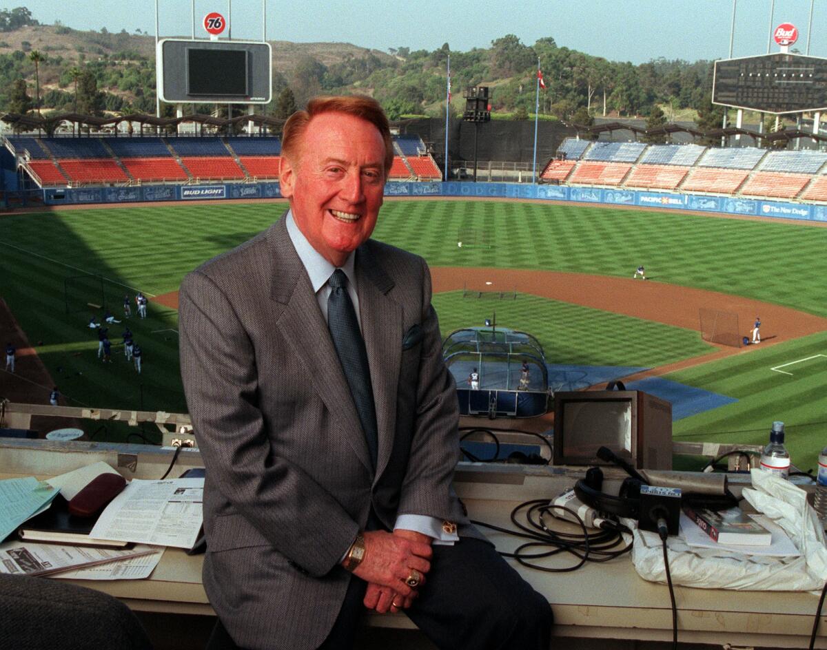 Vin Scully sits in the broadcasting booth at Dodger Stadium in 1999.
