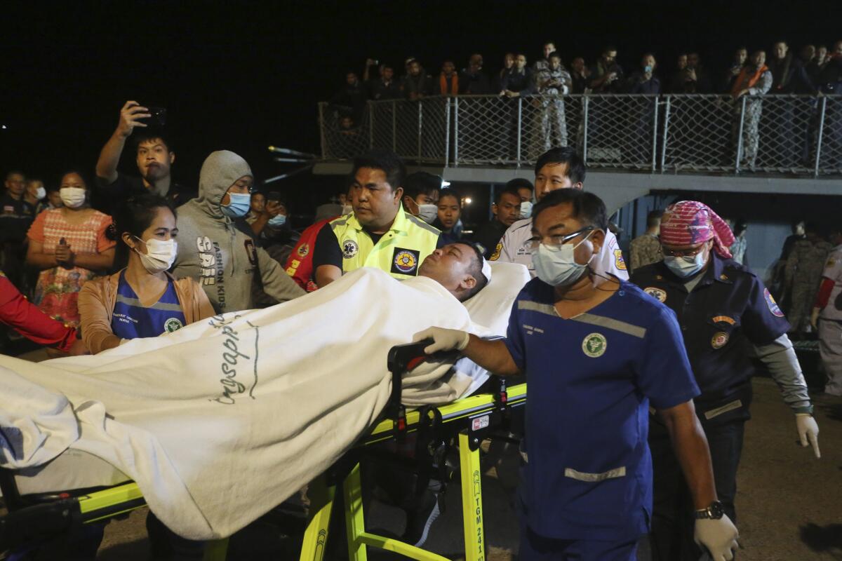 Rescued sailor being transferred to land on a stretcher