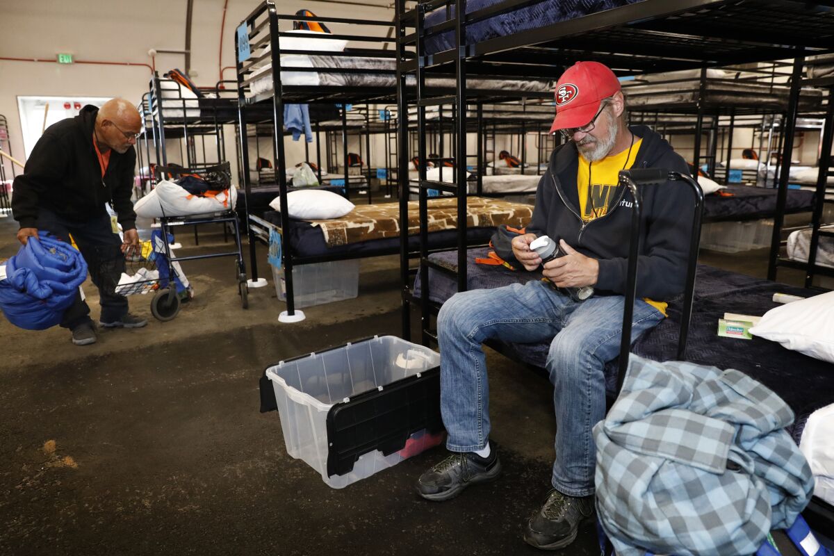 Robert Zepeda (left) and Mike Clayton, a Marine veteran, moved into the city's fourth bridge tent shelter which opened on Nov. 14, 2019.