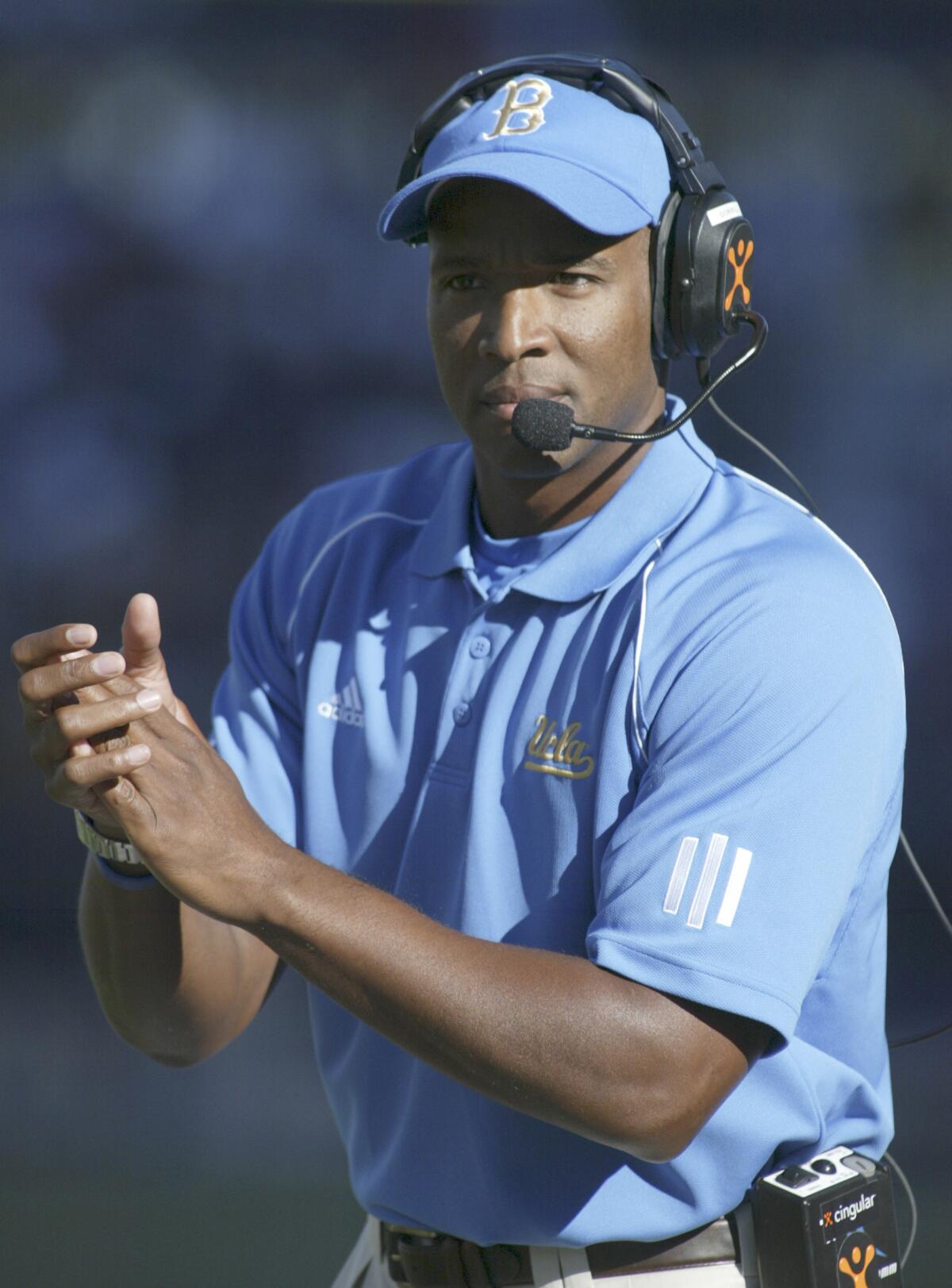 Karl Dorrell claps on the sideline while he was coach at UCLA.