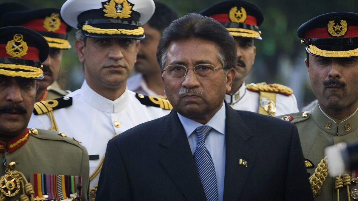Former President Pervez Musharraf is surrounded by top military officers as he leaves the presidential house in Islamabad on Aug. 18, 2008.