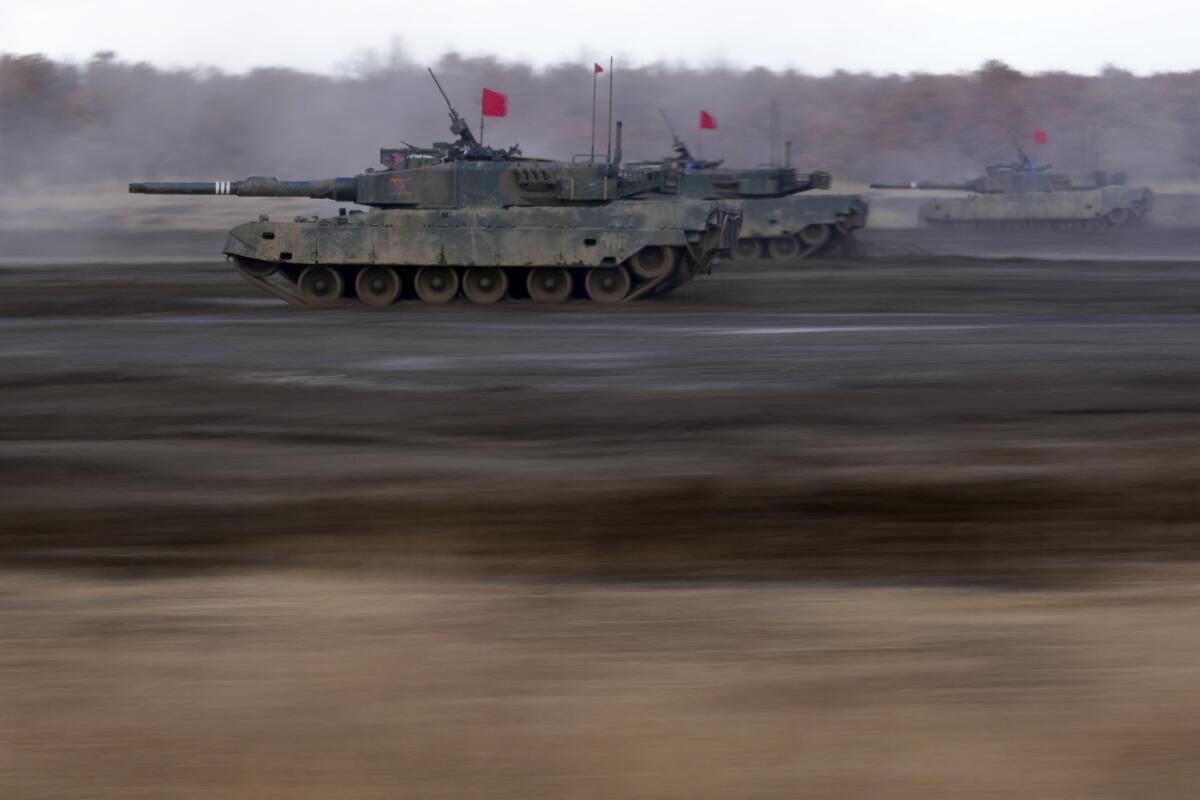 Japanese tanks driving toward target in drill