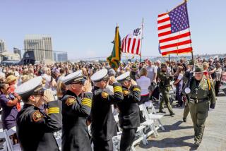 San Diego Firefighters officials, along with the public and other law enforcemnent, salute during a memorial for victims of the 911 terrorist in New York, Washington DC and Shankseville, PA, aboard the USS Midway in Downtown San Diego in San Diego CA on Saturday September 11, 2021.(Photo by Sandy Huffaker)