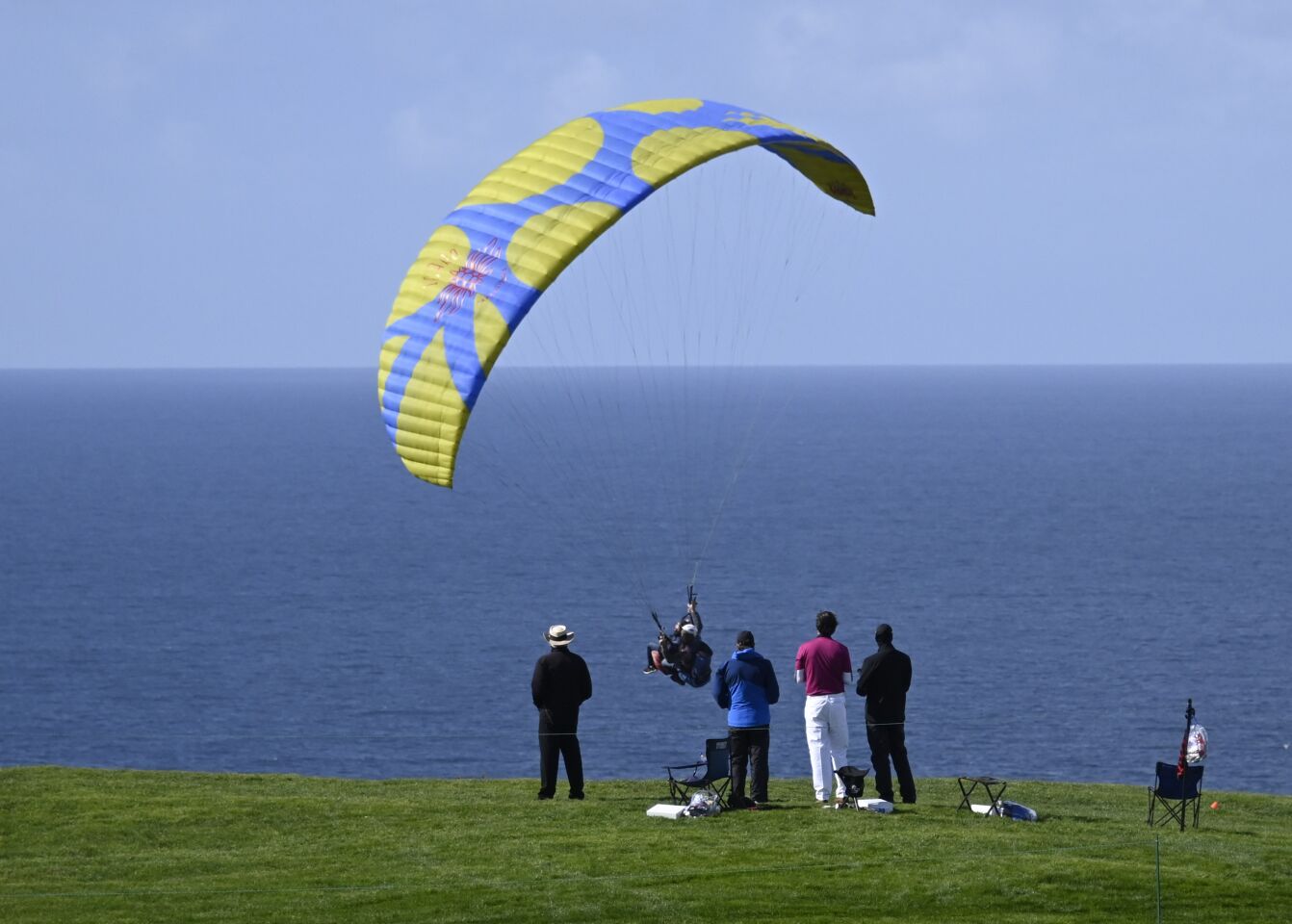 A group of golfers watch a paraglider on the fourth hole of the South Course during the second round of the Farmers Insurance Open golf tournament at Torrey Pines, Friday, Jan. 29, 2021, in San Diego. (Photo by Denis Poroy)