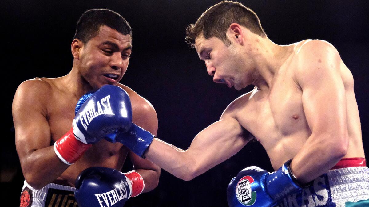 Carlos Cuadras, right, lands a punch against Roman Gonzalez during a WBC super-flyweight title fight last September.