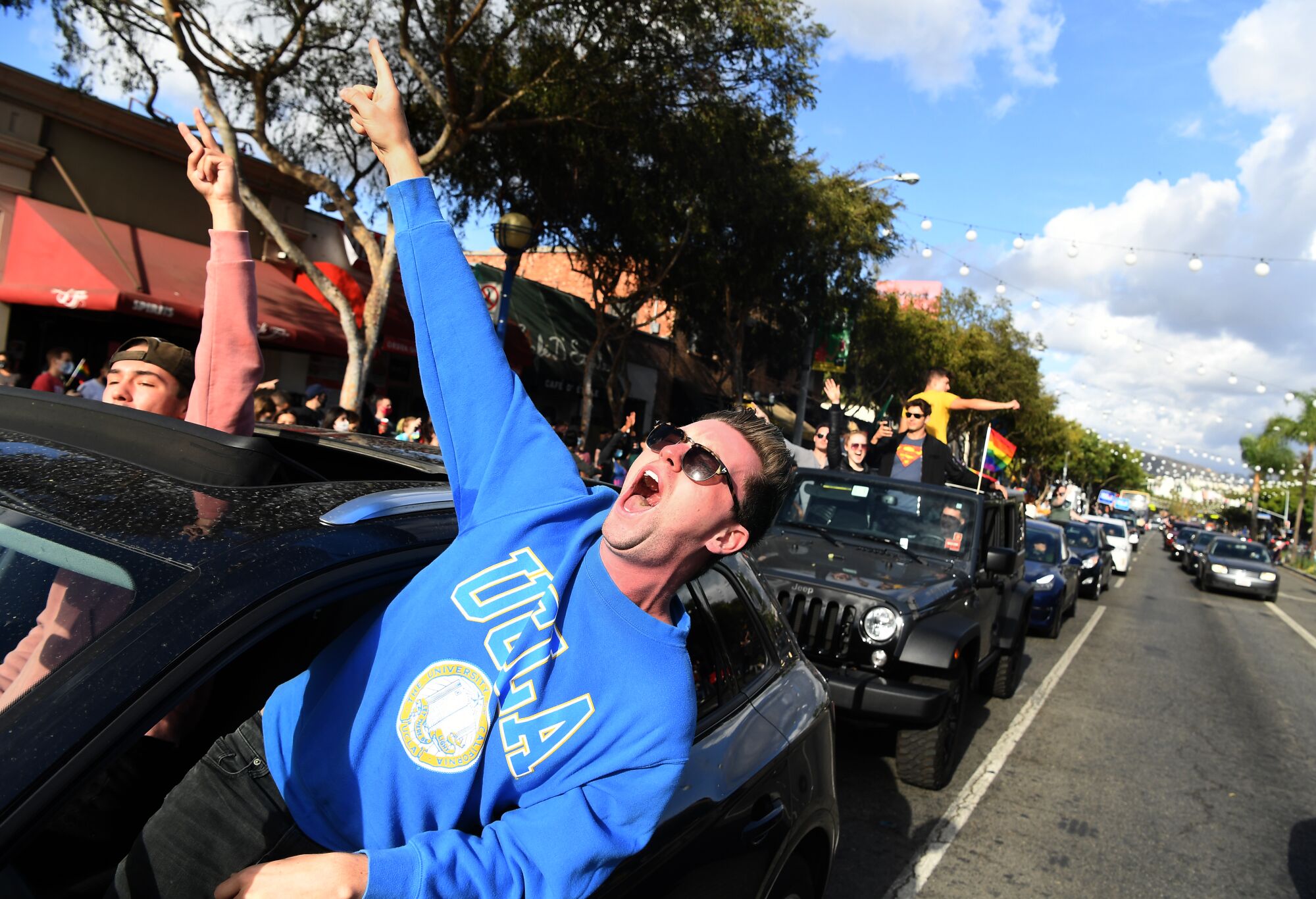 A Biden supporter yells from his car in celebration along Santa Monica Boulevard in West Hollywood.
