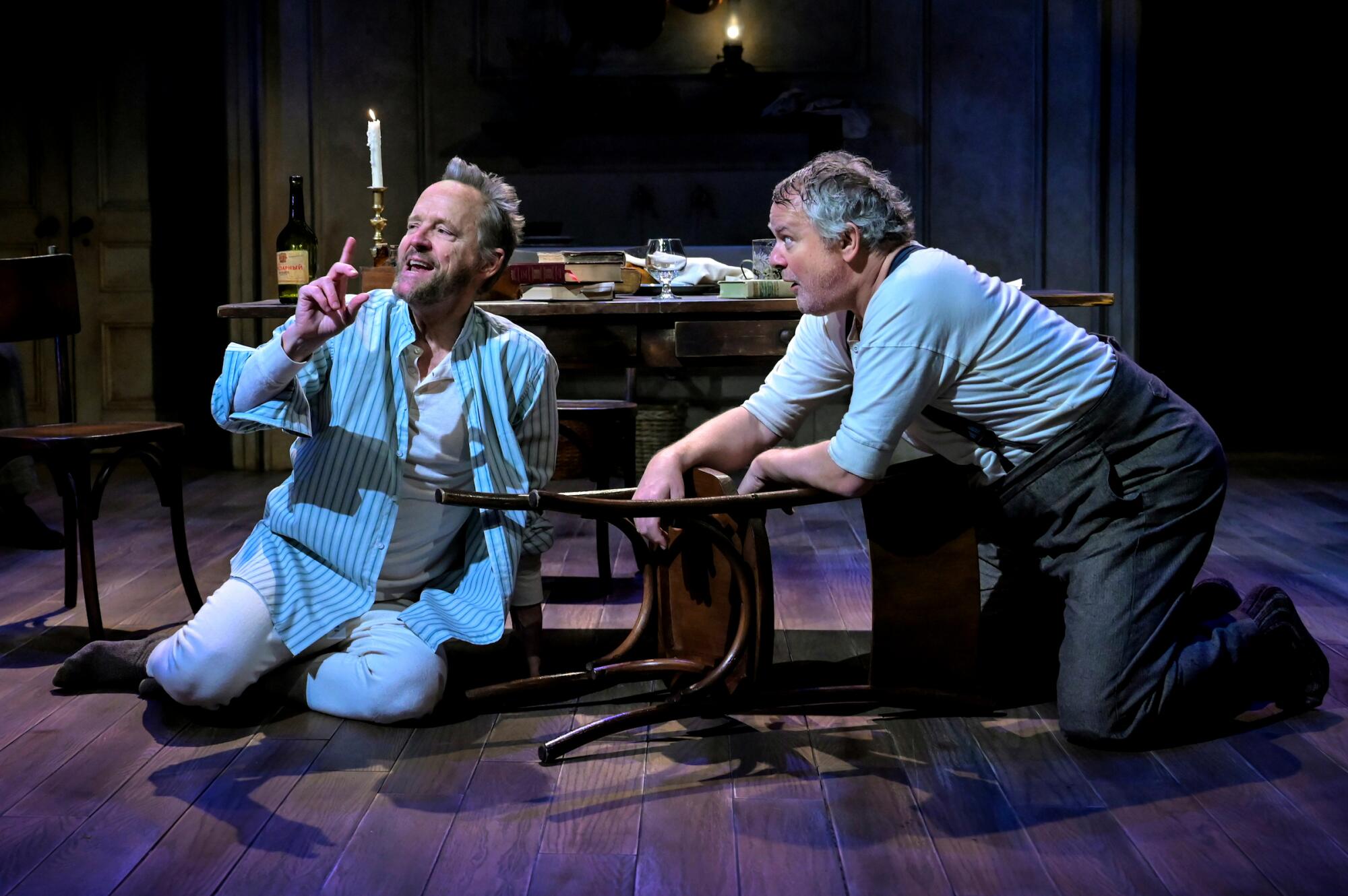 Two men sitting connected the level onstage.